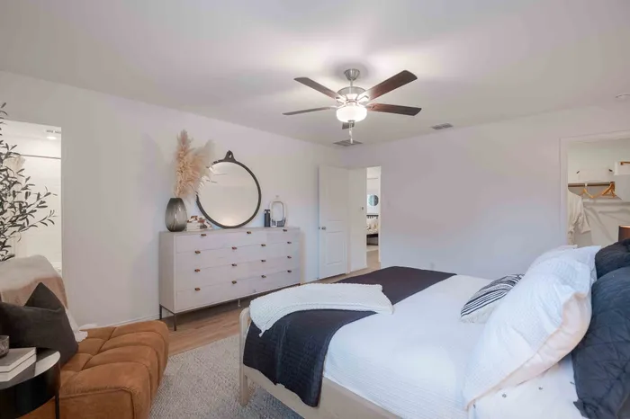 bedroom with hard surface floors and bed with white and blue bedding