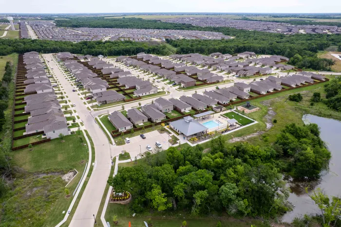 drone photo of clubhouse pool community and pond