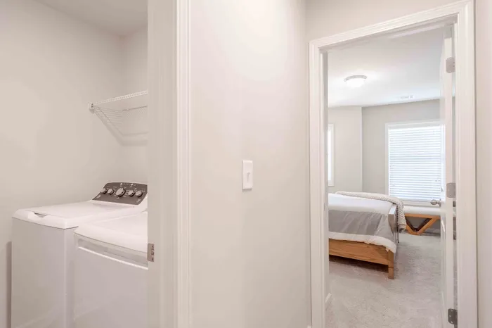full size washer dryer looking into bedroom