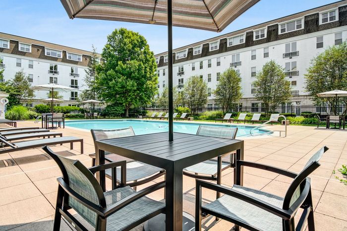 Resort-style swimming pool with sun deck & lounge seating