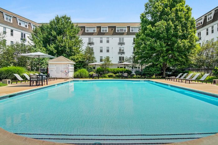 Resort-style swimming pool with sun deck & lounge seating