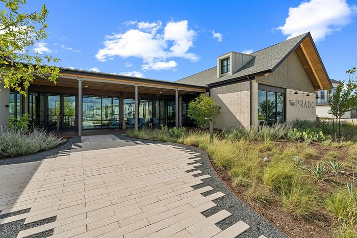 Leasing office with modern farmhouse architecture at The Prado apartments in Del Valle, TX