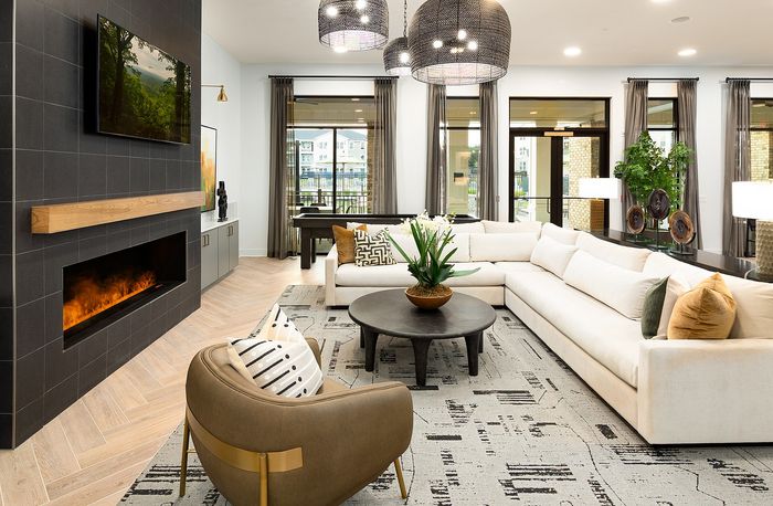 Stylish apartment clubhouse lounge with contemporary furniture, comfortable seating, and large windows.