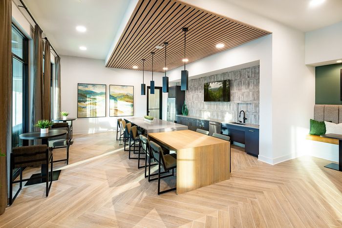 Community entertainment kitchen with a large island, seating, and contemporary finishes.