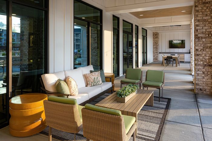 Covered outdoor lounge with comfortable seating, contemporary furnishings, and open-air views.