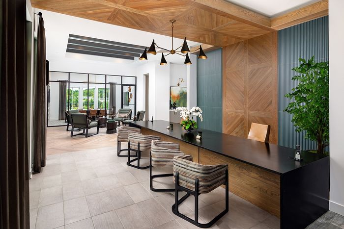 Modern apartment leasing office with contemporary furnishings, comfortable seating, and welcoming interiors.