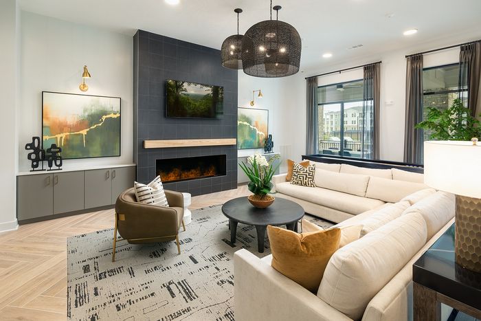 Modern resident lounge with contemporary furnishings, comfortable seating, and bright, open gathering areas.
