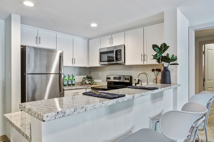 Kitchen with white cabinetry and breakfast bar
