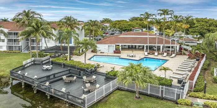 Building exterior with swimming poll and sitting area