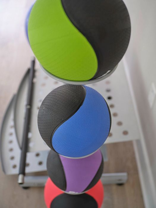Vibrant stack of colorful yoga balls brighten a modern home gym corner.
