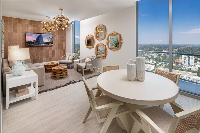 Luxurious living room with elegant decor and stunning city view, featuring contemporary furniture and stylish wall art.