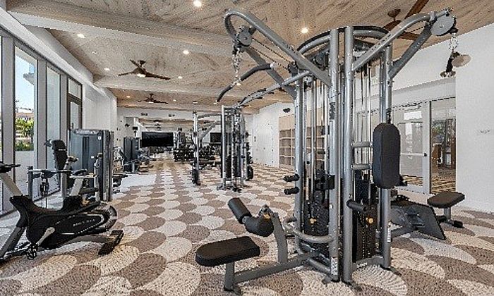 Modern fitness center with state-of-the-art equipment, spacious layout, and stylish design for an ideal workout experience.