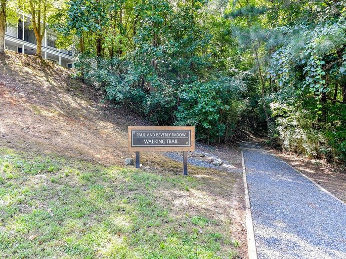 Inviting walking trail surrounded by lush greenery, offering a serene nature retreat.