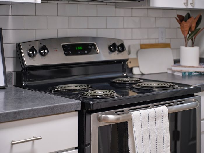 Modern kitchen featuring a sleek stainless steel stove with a cozy and inviting countertop arrangement.