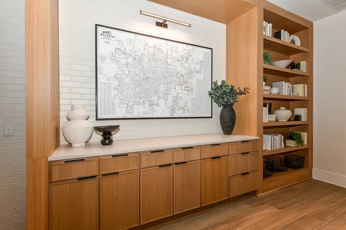 Elegant built-in shelving unit with decorative vases and greenery, featuring a large framed city map for stylish storage and display.