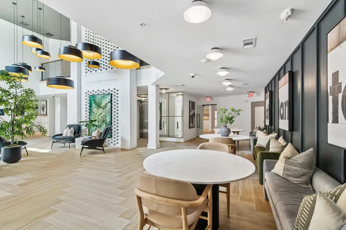 Chic communal area with elegant lighting, comfortable seating, and stylish decor, perfect for social gatherings.