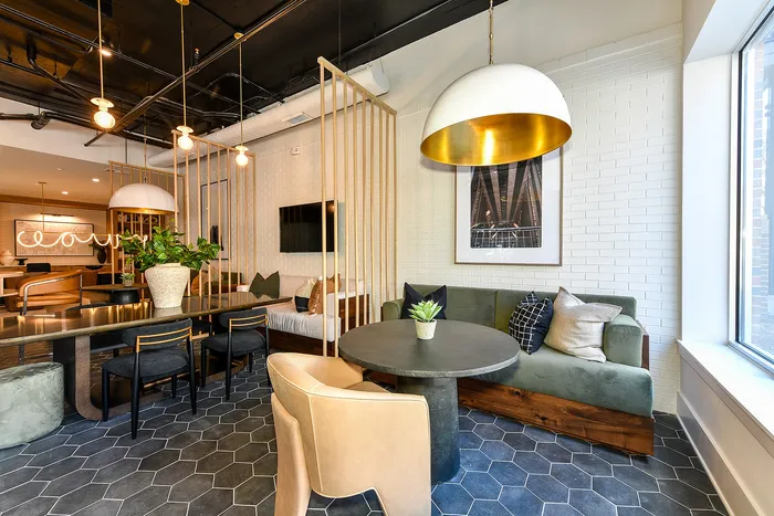 Sleek and modern living space with stylish furniture, warm lighting, and vibrant greenery, offering a cozy and inviting atmosphere.