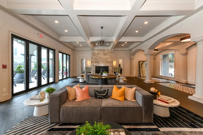 Elegant and spacious living area featuring modern decor, luxurious seating, large windows, and stylish lighting for a sophisticated ambiance.