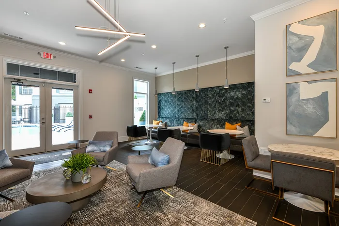 Sophisticated lounge area with modern seating, chic lighting fixtures, and stylish decor, offering a welcoming ambiance by the poolside.