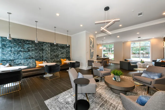 Chic and modern lounge area with stylish furniture, featuring cozy seating, sleek tables, and ambient lighting, perfect for gatherings.