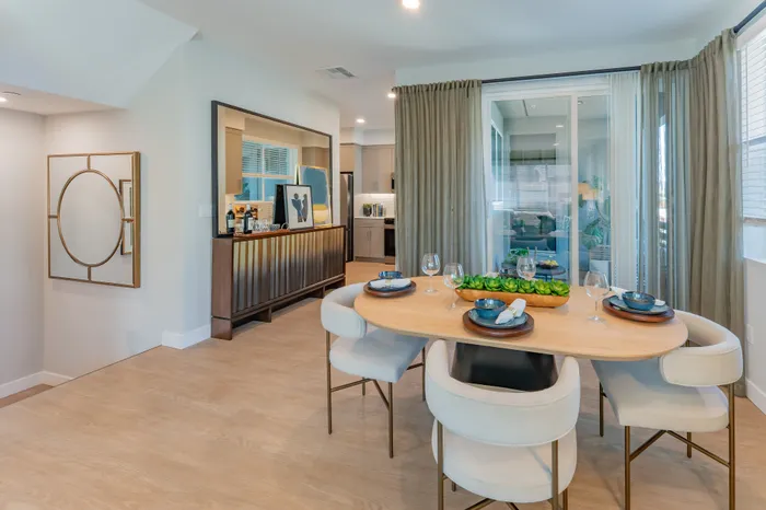 Elegant dining area featuring modern furniture, table settings, and an open‑concept kitchen at Marlowe Palomar Heights new apartments in Escondido, CA.