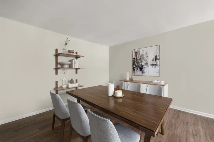 Elegantly furnished dining room with a wooden table, six stylish chairs, modern decor, and a chic wall painting.