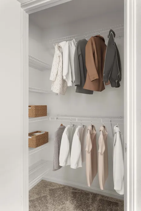 Organized walk-in closet with sleek wire shelving and stylish coats, showcasing efficient storage solutions.