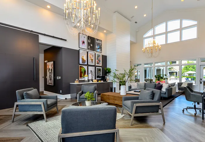 Elegant and spacious lobby with modern seating, large windows, and stunning chandeliers, creating a welcoming and luxurious atmosphere.