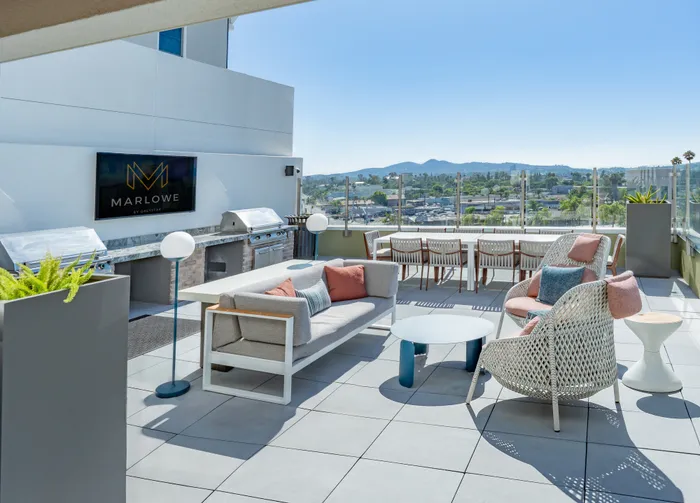 rooftop terrace with outdoor seating and grill area