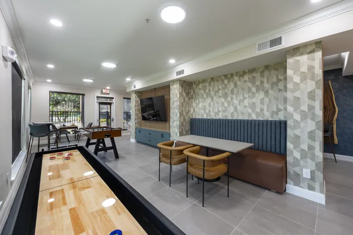 Chic and inviting communal lounge with modern games, plush seating, and stylish decor, perfect for social gatherings.