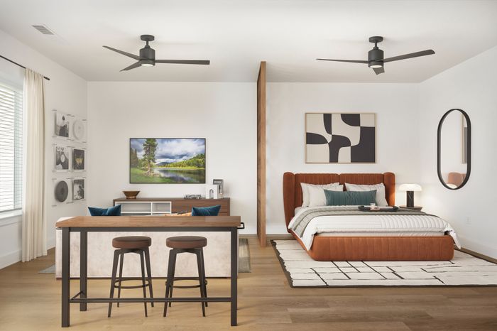 Modern bedroom with elegant furnishings, featuring a stylish bed, chic decor, and a cozy seating area with bar stools, perfect for relaxation.