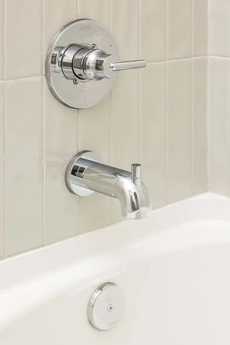 Elegant bathroom fixture with a sleek chrome faucet and modern tile backdrop, exuding contemporary style.