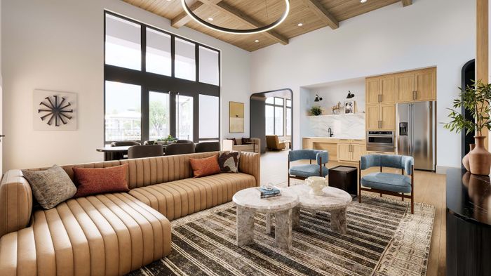Stunning modern living room with high ceilings, natural light, and open-concept design featuring a stylish kitchen and cozy seating area.