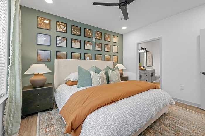 Elegant bedroom featuring cozy bedding, tasteful wall art, and soft ambient lighting for a tranquil retreat.