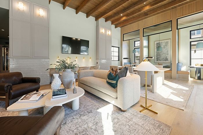 Elegant living room with modern decor, cozy seating, and large windows offering abundant natural light.