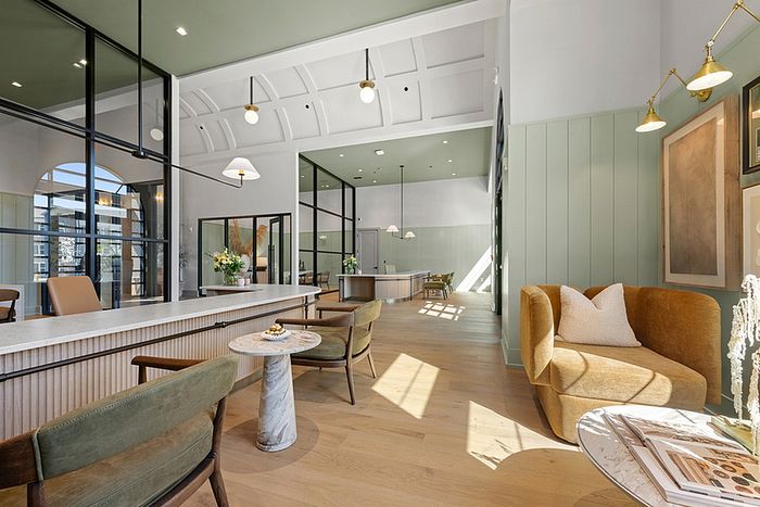 Elegant and modern apartment lobby featuring sleek furnishings, soft lighting, and a welcoming atmosphere.