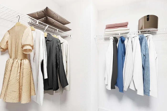 Spacious walk-in closet with organized shelving, neatly arranged clothes, and stylish storage solutions.