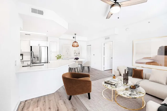 Contemporary open-concept living area with elegant decor, featuring plush seating, a modern kitchen island, and stylish accent pieces.