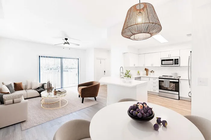 Bright and modern open-concept living space with sleek kitchen, cozy living room, elegant lighting, and a stylish dining area.