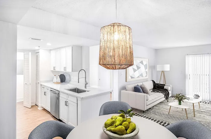 Chic open-plan apartment with modern kitchen, cozy living area, stylish pendant light, and elegant dining space.