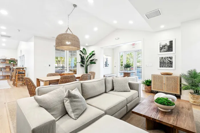 Bright and modern open-concept living space with cozy seating, elegant dining area, and abundant natural light.