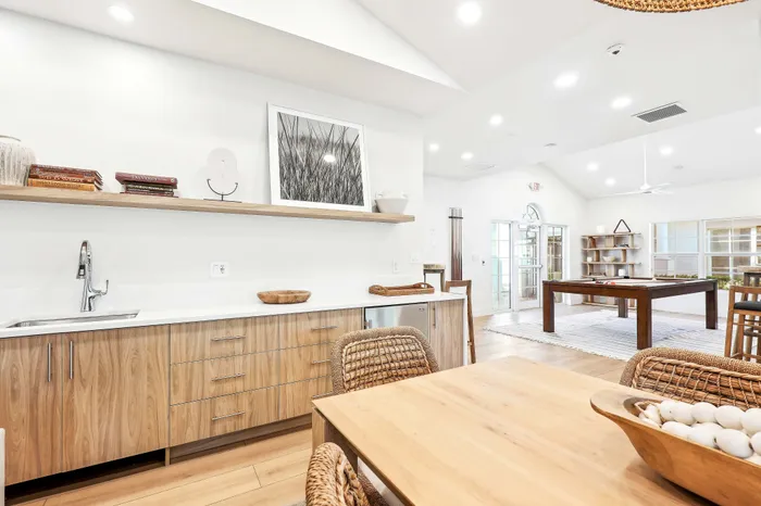 Chic open-concept living area with modern wooden kitchen, dining space, and stylish décor, perfect for entertaining.