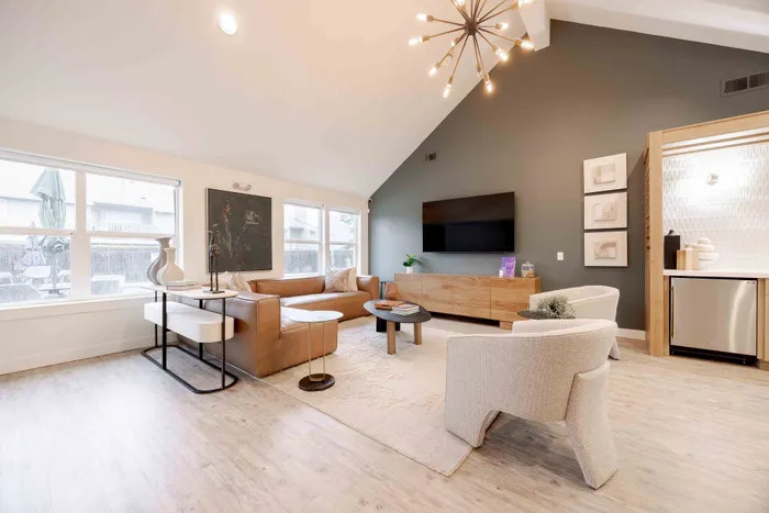 Inviting modern living room with trendy lighting, elegant furniture, and spacious layout, perfect for relaxation and entertainment.