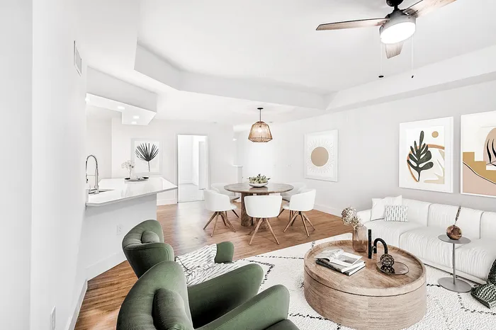 Chic open-concept living area featuring modern furniture, stylish decor, and a cozy dining space adjacent to a sleek kitchen.