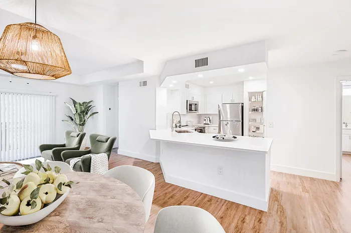Elegant open-concept living area with modern kitchen, stylish dining, and cozy lounge seating.