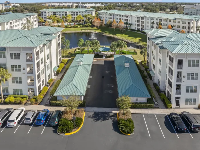 Vibrant apartment complex with modern architecture, lush greenery, and a serene pond featuring a central fountain, perfect for a tranquil lifestyle.