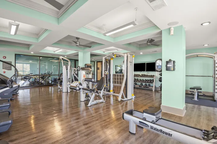 Bright and inviting gym with modern exercise equipment and spacious layout, ideal for fitness enthusiasts.
