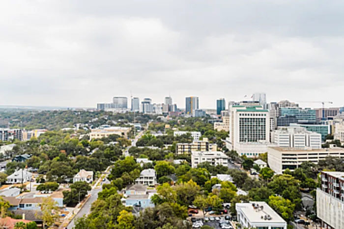Breathtaking cityscape view showcasing vibrant greenery and modern skyline, ideal for urban living.