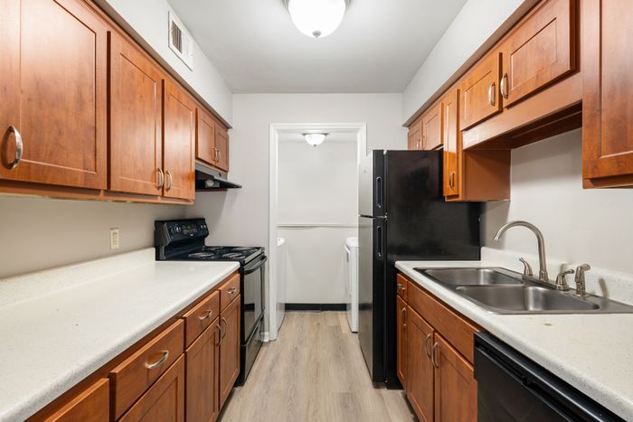 Charming modern kitchen with sleek countertops, warm wooden cabinets, and updated appliances.
