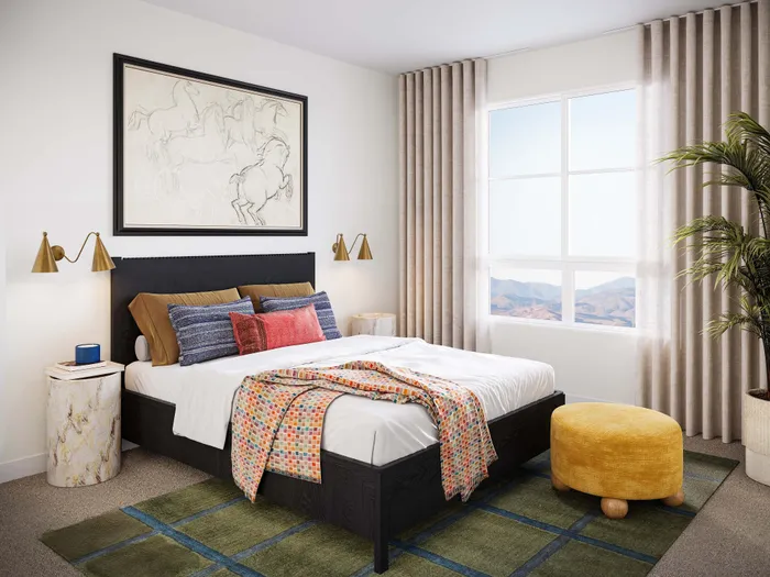 Chic bedroom with stunning mountain view, plush bed, vibrant cushions, and elegant decor elements.